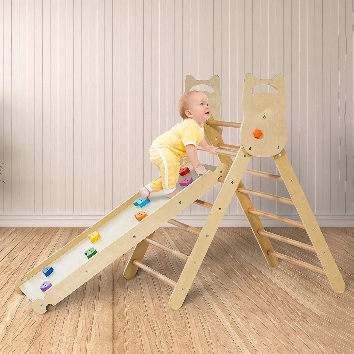 Un bébé grimpant le long d'un triangle Pikler
